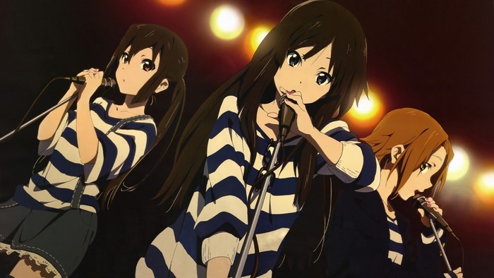 Anime girls singing on stage with microphones
