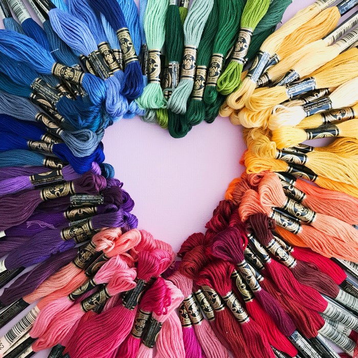 Heart shape made of colorful embroidery threads