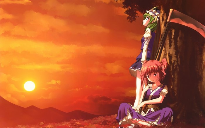 Two girls with a scythe at sunset