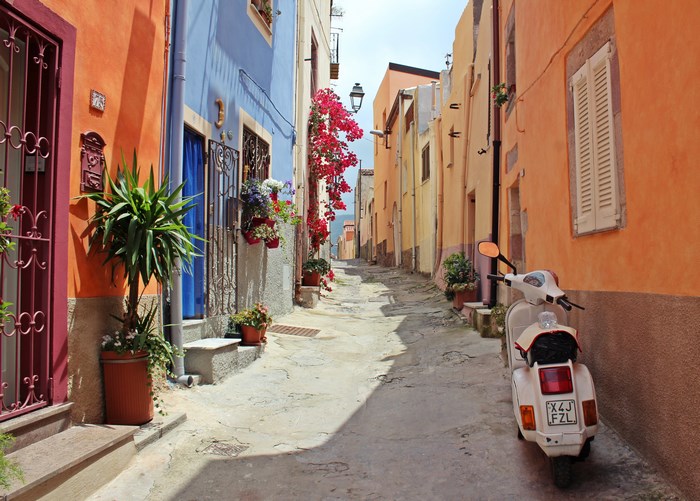Street in Italy with colorful buildings and scooter