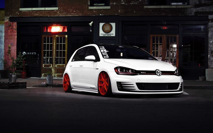 White Volkswagen Golf GTI with red wheels