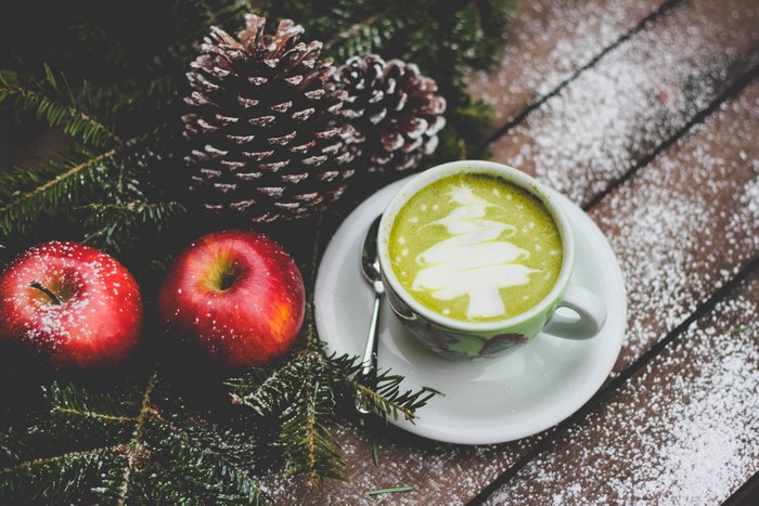 Christmas tree latte art with apples and pine cones
