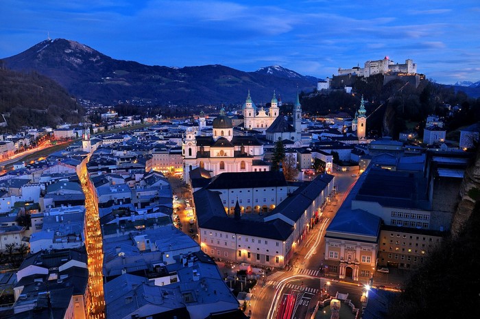 Salzburg cityscape at dusk with Hohensalzburg Fortress