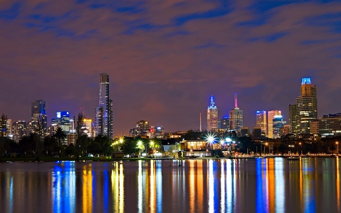 Melbourne skyline at night with water reflections