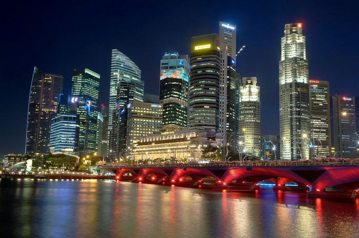 Singapore skyline at night with illuminated bridge