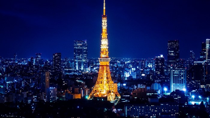Tokyo Tower illuminated at night over cityscape