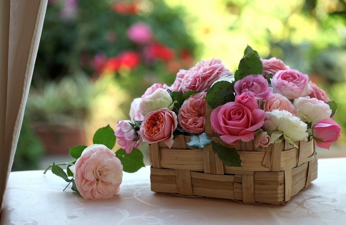 Delicate Pink Roses Arranged in a Wooden Basket