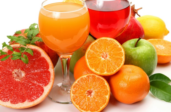 Fresh Citrus Fruits and Juices in Glasses