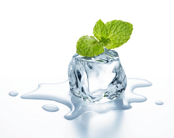 Ice cube with mint leaves and water
