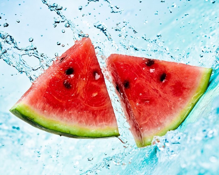 Watermelon slices splashing in water