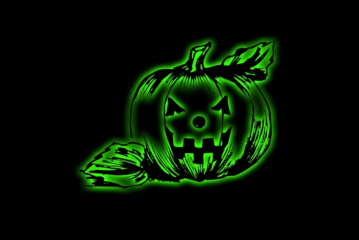Scary glowing green jack-o'-lantern with leaves