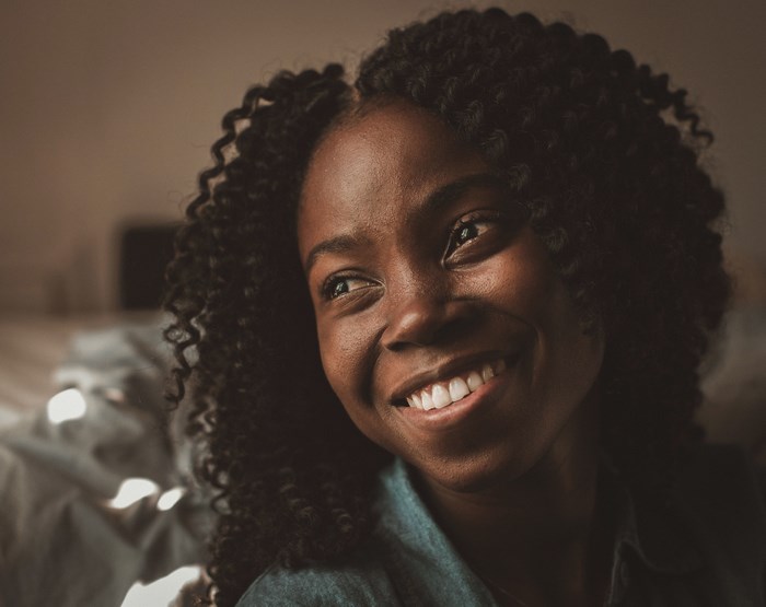 Close up portrait of a smiling woman with curly hair