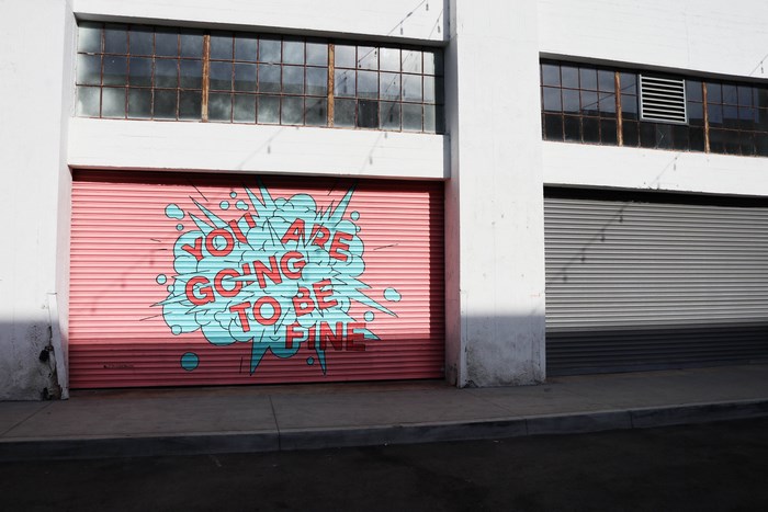 Mural on a pink garage door: "You are going to be fine"