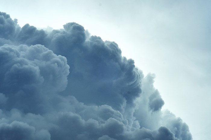 Dark storm clouds against a bright sky