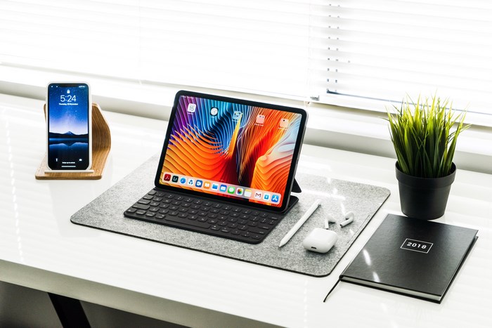 Minimal desk setup with iPad Pro and iPhone
