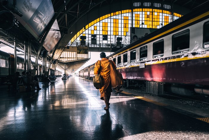 Monk walking at Bangkok train station
