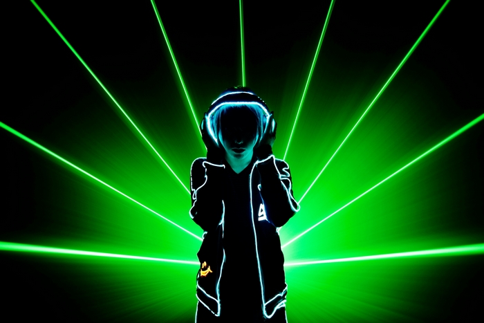 Person in headphones with green laser lights