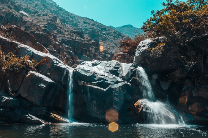 Waterfall cascading over rocks in a mountainous landscape