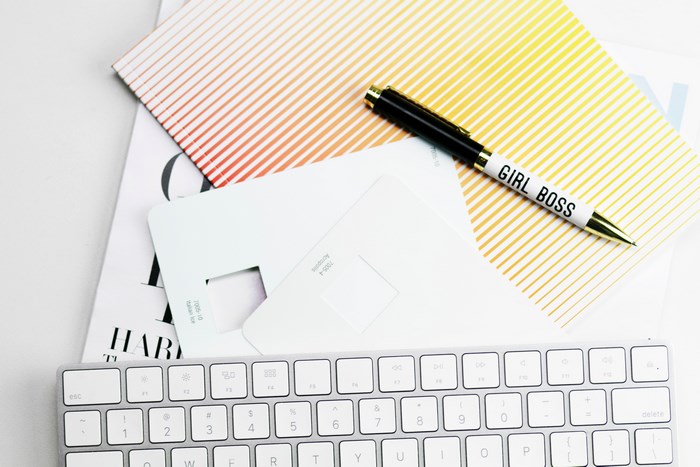 Girl Boss Pen on Magazine and Keyboard