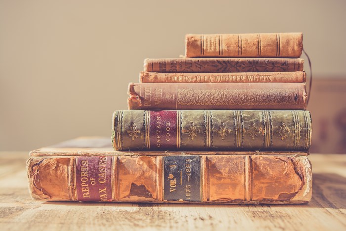 Stack of antique books on a wooden table