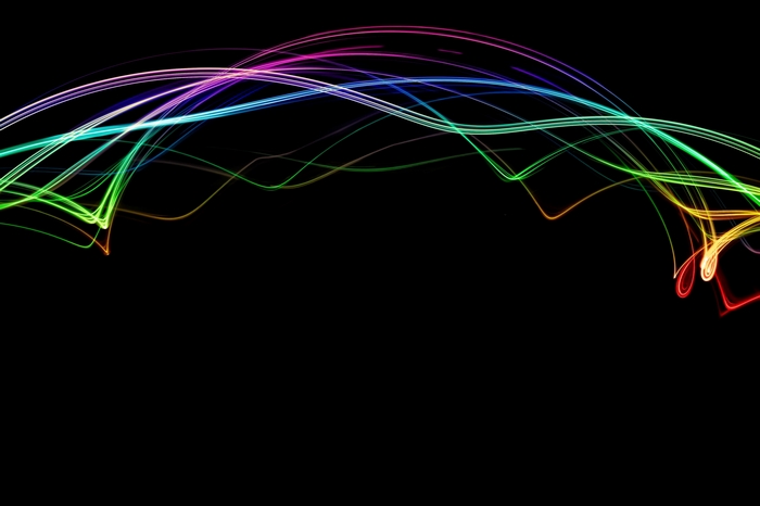 Rainbow light streaks on black background