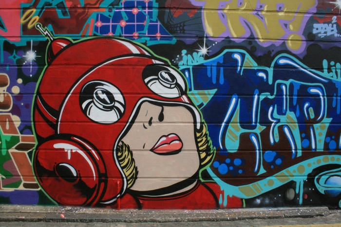 Graffiti of a woman in a red helmet