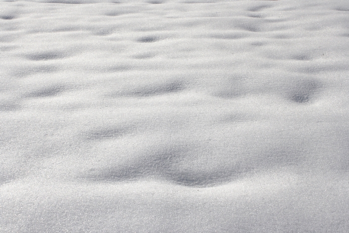 Snowy ground with undulating drifts