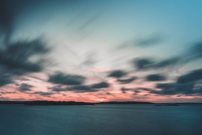 Long exposure of ocean and clouds at sunset