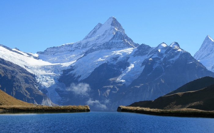 Snow-capped mountains reflected in a lake