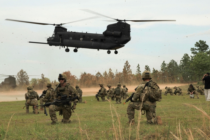 Soldiers kneeling as helicopter lands