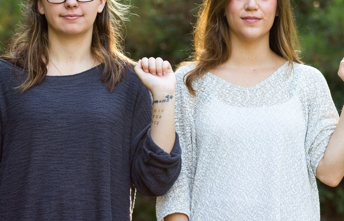 Two women with arms raised