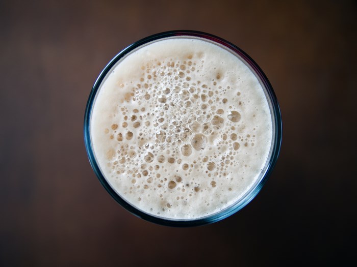 Top-down view of a glass of beer with foam