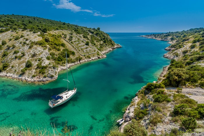 Sailboat anchored in a Mediterranean cove
