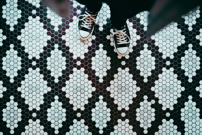 Black and white hexagonal tile pattern with shoes