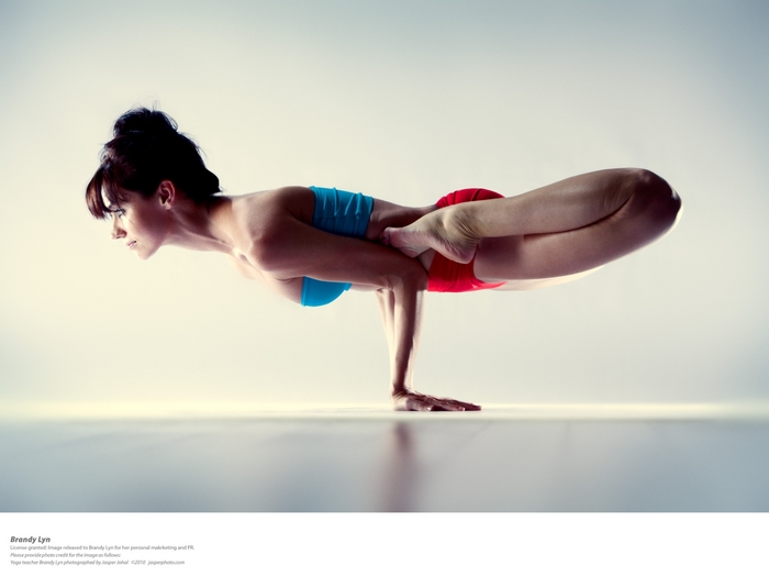 Woman performing yoga pose on hands