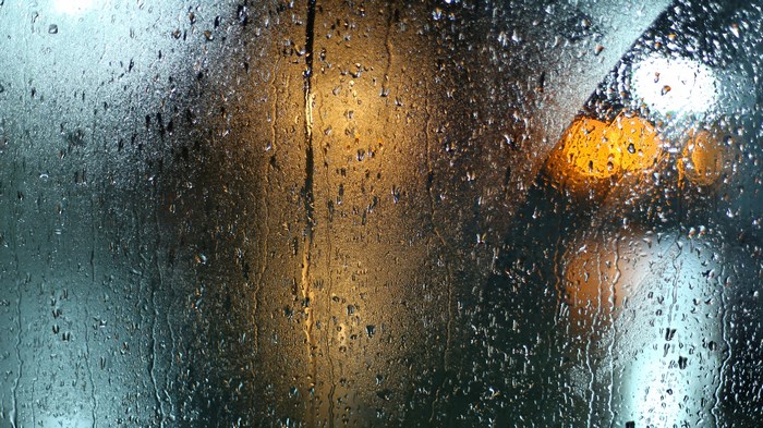 Rainy night through a window with bokeh lights