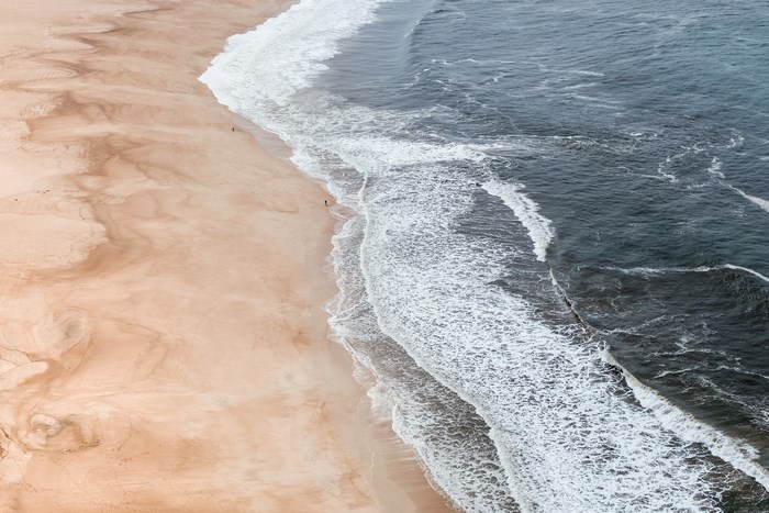 Serene Ocean Waves Meeting Sandy Beach