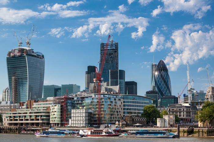 London skyline with skyscrapers and river boats