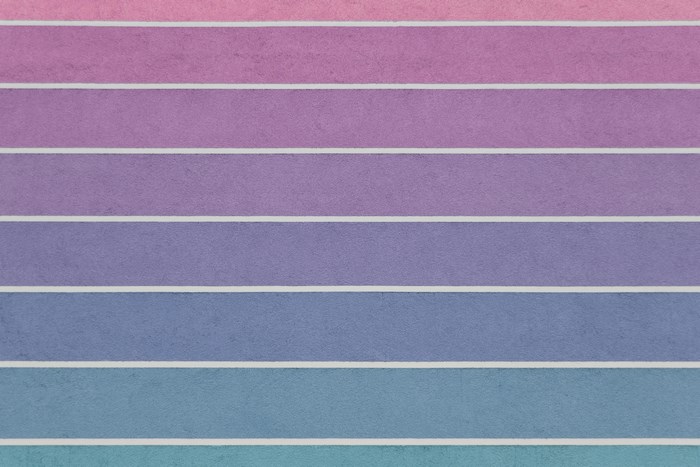 Horizontal lines of pink, purple, and blue stucco