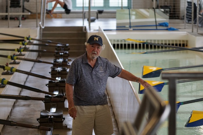 Man in Navy Cap at Rowing Facility