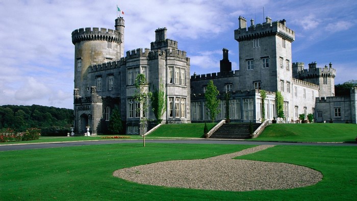 Castle with a flag on a hill under a blue sky