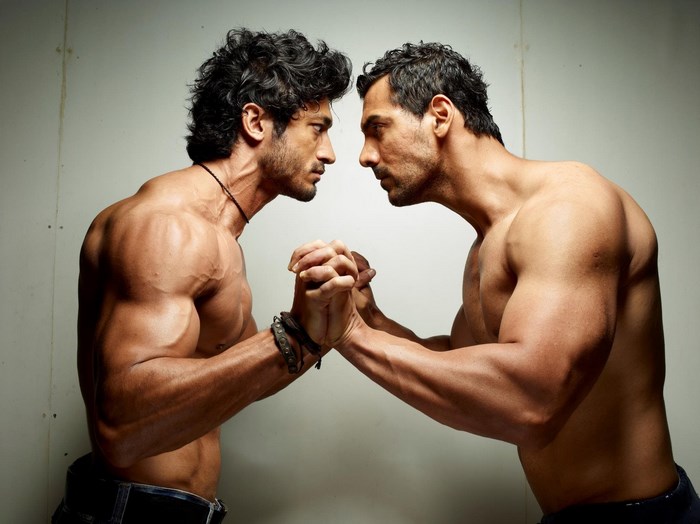 Two muscular men arm wrestling