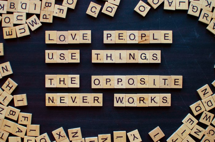 Scrabble tiles spell out a quote about love and things