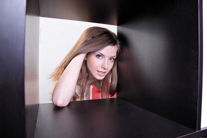 Anita C Leaning Inside a Black Shelf