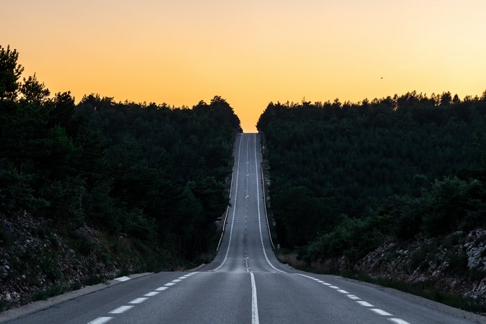 Road through a forest at sunset in Luberon