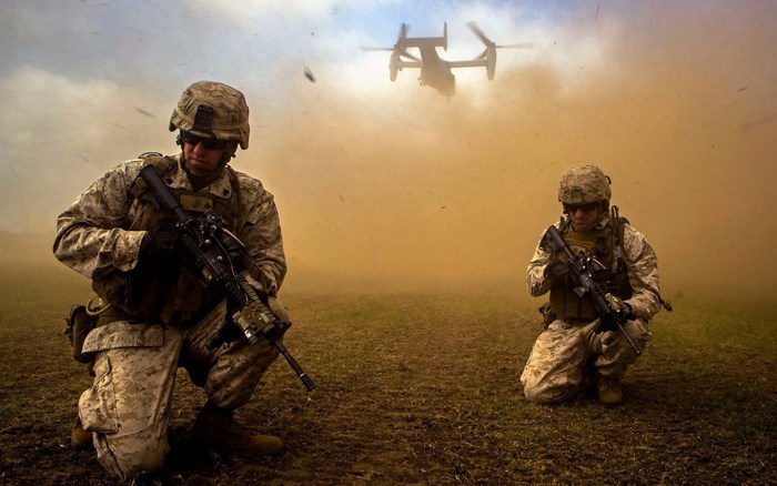Soldiers in Combat Gear with Aircraft in Dusty Field