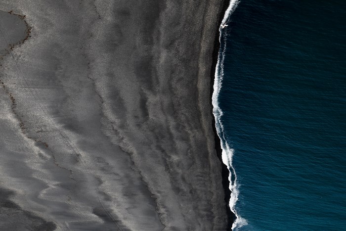Aerial view of black sand beach and ocean in Iceland