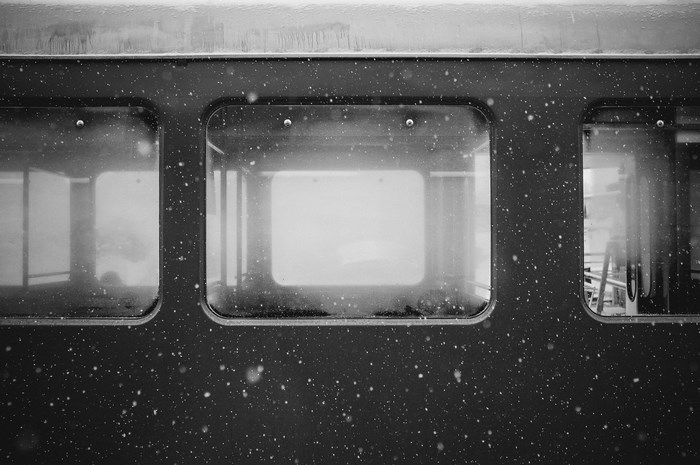 Train car window in winter with snow