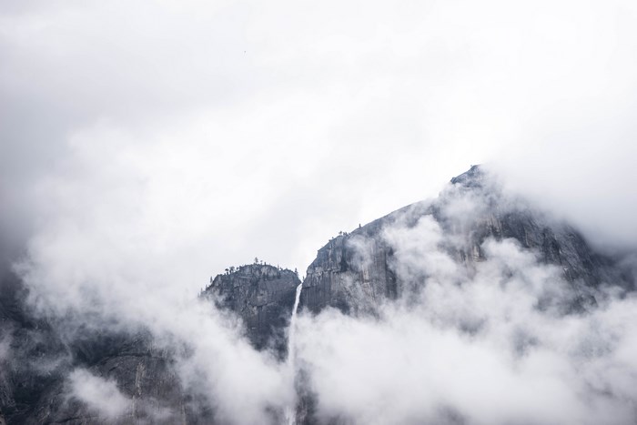 Misty mountains with a waterfall