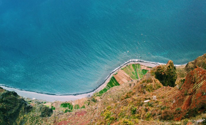 Aerial view of terraced fields by the ocean cliff